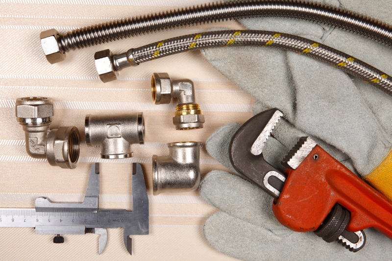 Plumber working on pipes in a Finchley Central home